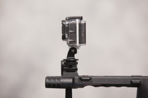 GoPro mounted on top of a Panasonic video camera via the use of a hot shoe adapter.